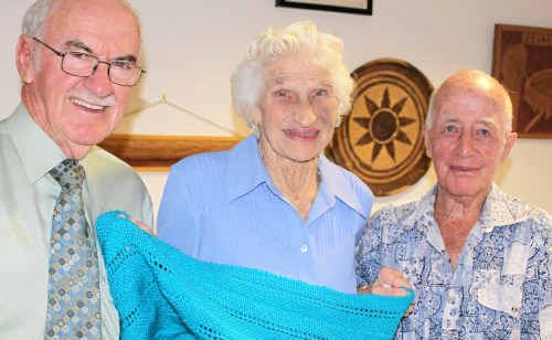 Phyllis and Len Acworth donate the blanket to Mayor Ron Bellingham.
